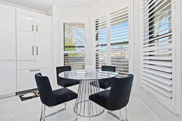 a view of a dining room with furniture and windows