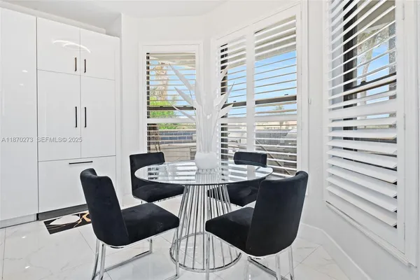 a view of a dining room with furniture and window