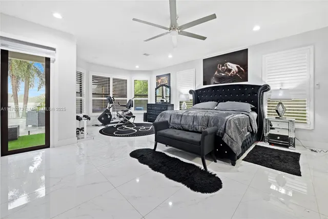 a bedroom with a bed couch and a large window