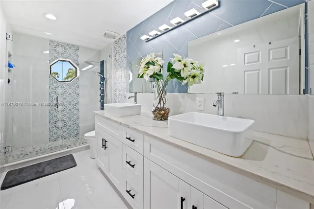 a bathroom with a sink a toilet and shower curtain