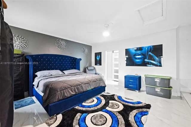a bedroom with a large bed and a flat screen tv