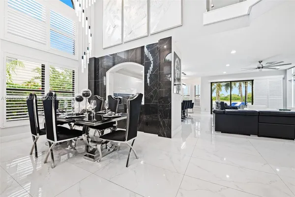 a living room with furniture a rug and a chandelier