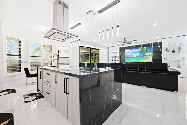 a kitchen with stainless steel appliances kitchen island granite countertop a stove and a sink