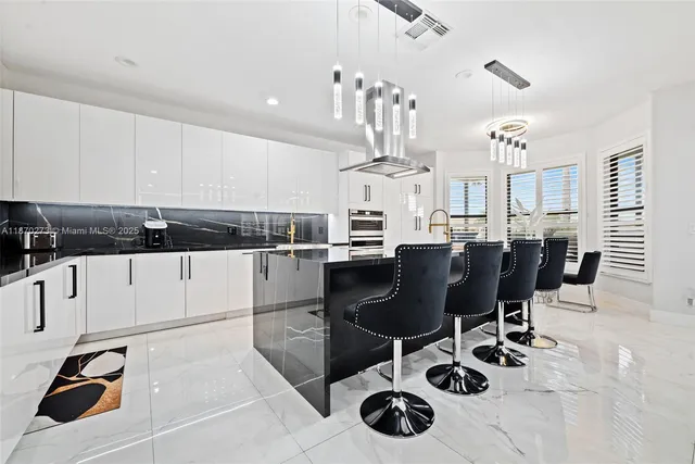 a kitchen with a sink a stove and white cabinets