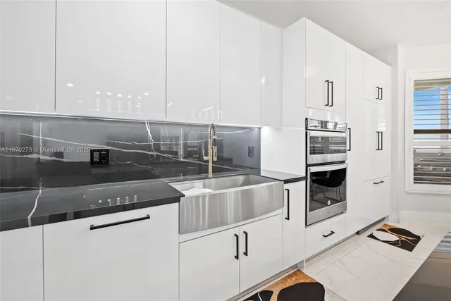 a kitchen with stainless steel appliances granite countertop a sink and a stove