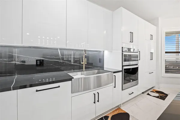 a kitchen with stainless steel appliances granite countertop a sink and a stove
