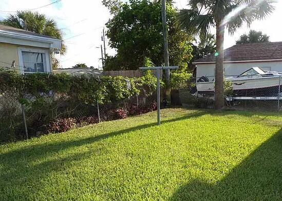 3391 Avenue South Riviera Beach, FL 33404 - Photo 16 of 16 a view of a backyard with a garden and entertaining space