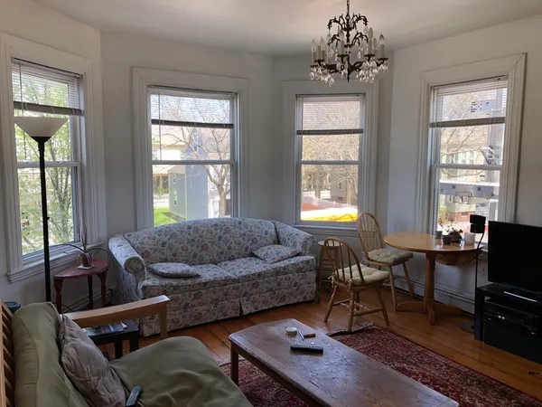 a living room with furniture and a chandelier