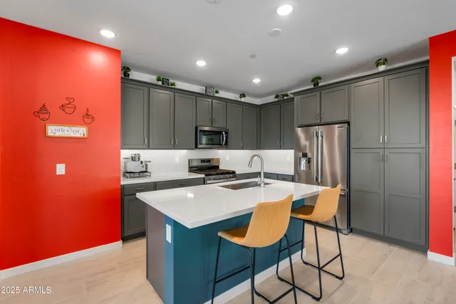 a kitchen with a table chairs and living room
