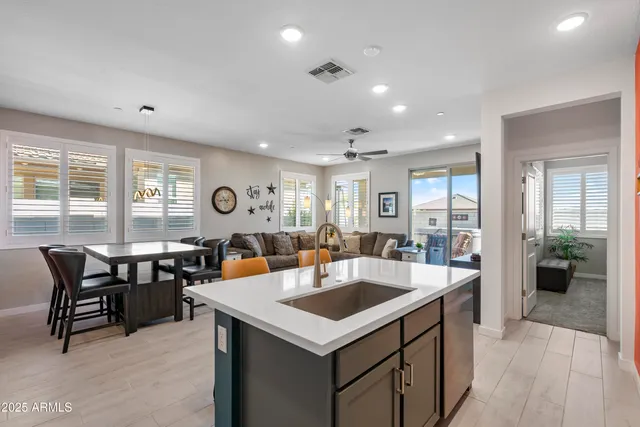 a bedroom with a bed a window and a dresser