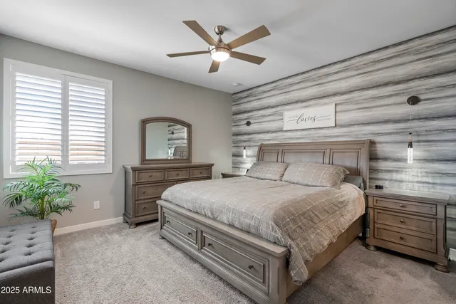 a bedroom with a bed and a chandelier