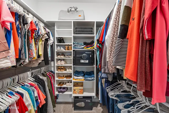 a en suite bathroom with a double vanity sink a mirror and a bathtub