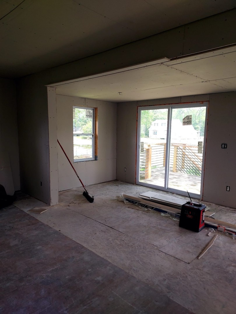 24689 North Fox River Road Cary, IL 60013 - Photo 2 of 6 a view of an empty room with wooden floor and a window