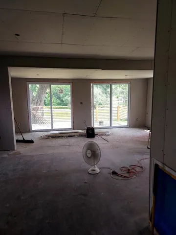 a room with pool table and windows