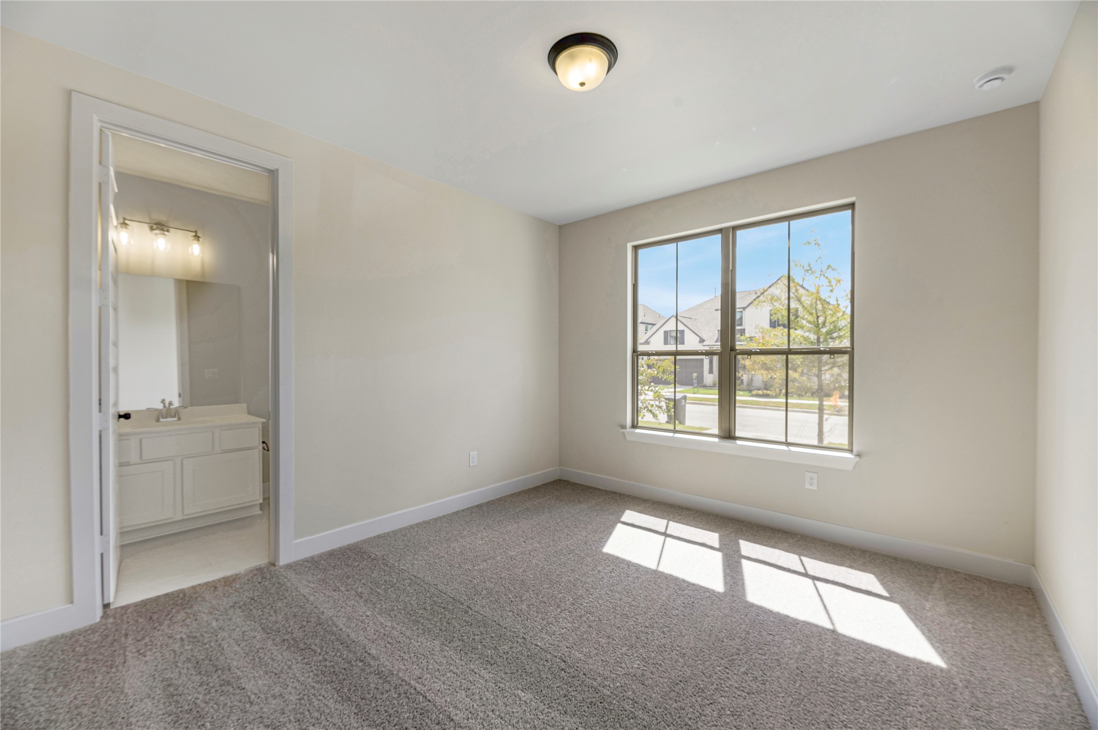1508 Rodeo Ridge Drive Georgetown, TX 78628 - Photo 14 of 37 Unfurnished bedroom featuring light carpet and ensuite bath