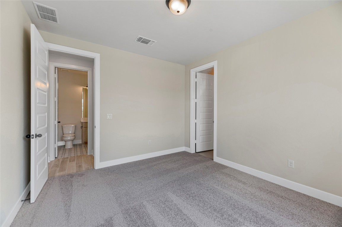 1508 Rodeo Ridge Drive Georgetown, TX 78628 - Photo 15 of 37 Unfurnished bedroom with light carpet and baseboards