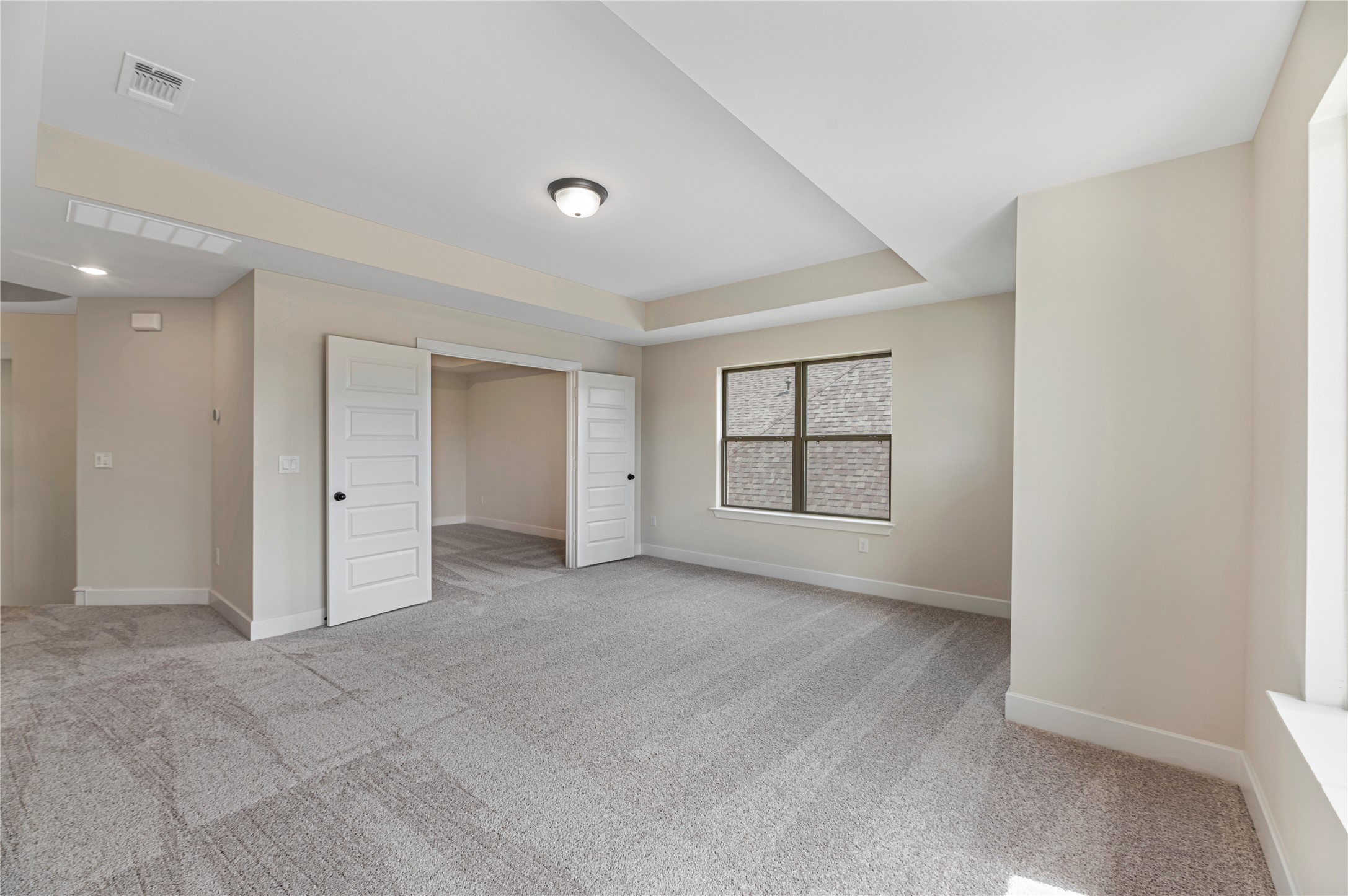 1508 Rodeo Ridge Drive Georgetown, TX 78628 - Photo 19 of 37 Unfurnished bedroom with light colored carpet and a tray ceiling