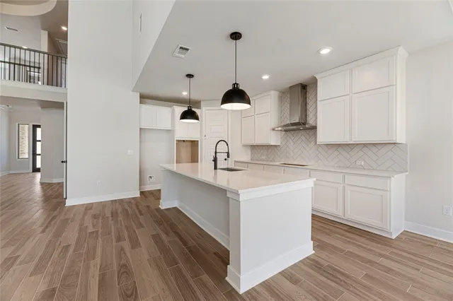 a spacious bathroom with a double vanity sink mirror and bathtub