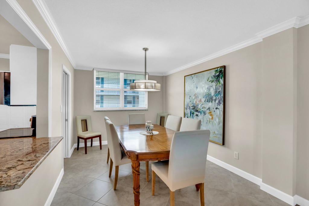 4601 Florida A1A, Unit 405 Vero Beach, FL 32963 - Photo 15 of 36 a dining room with furniture and window