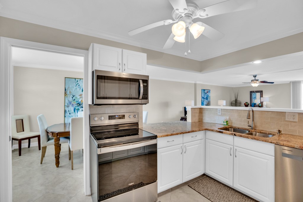 4601 Florida A1A, Unit 405 Vero Beach, FL 32963 - Photo 18 of 36 a kitchen with a stove and a microwave