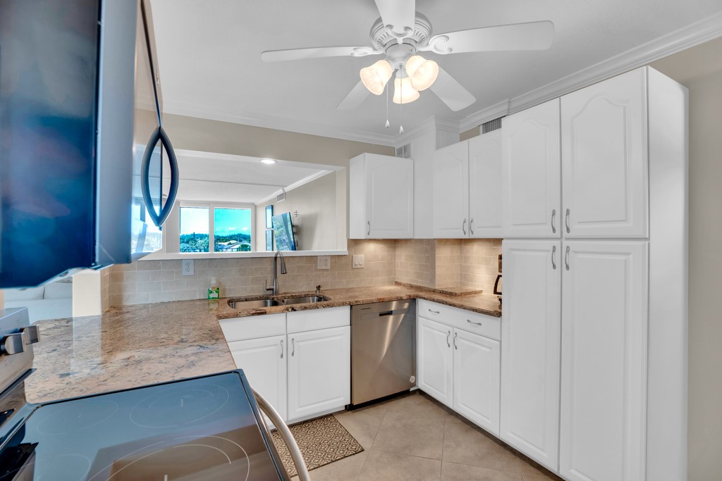 4601 Florida A1A, Unit 405 Vero Beach, FL 32963 - Photo 20 of 36 a kitchen with a sink a counter top space cabinets and stainless steel appliances