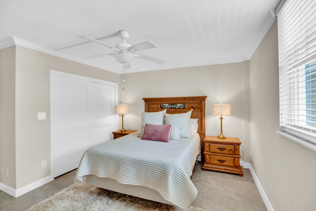 4601 Florida A1A, Unit 405 Vero Beach, FL 32963 - Photo 24 of 36 a bedroom with a bed and wooden floor