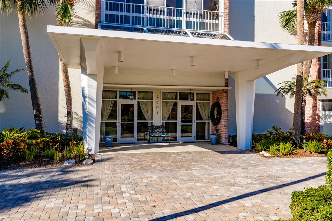 4601 Florida A1A, Unit 405 Vero Beach, FL 32963 - Photo 30 of 36 a front view of a building with a potted plant