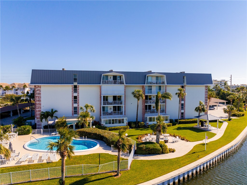 4601 Florida A1A, Unit 405 Vero Beach, FL 32963 - Photo 32 of 36 a view of a swimming pool with outdoor seating