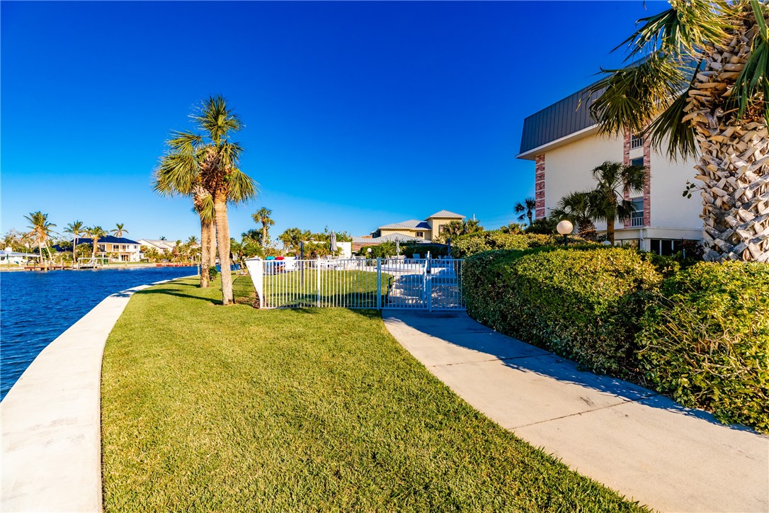4601 Florida A1A, Unit 405 Vero Beach, FL 32963 - Photo 36 of 36 a swimming pool with outdoor seating and yard