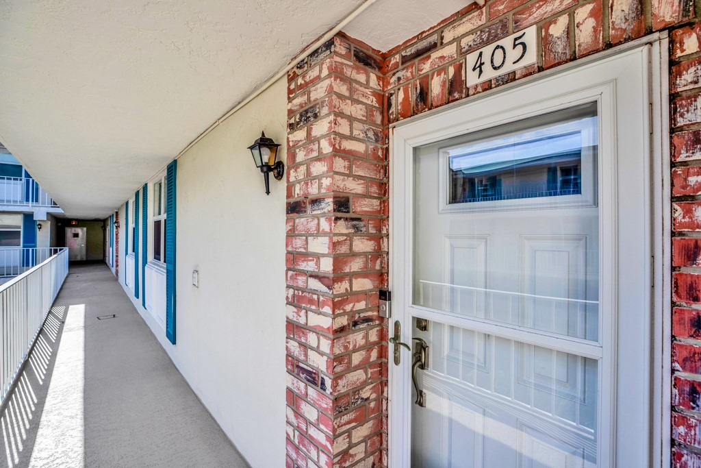 4601 Florida A1A, Unit 405 Vero Beach, FL 32963 - Photo 10 of 36 a view of a hallway with wooden floor and staircase