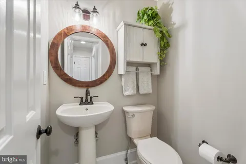 a kitchen with sink and view of living room
