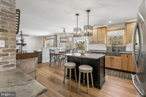a open kitchen with stainless steel appliances granite countertop a stove and kitchen island