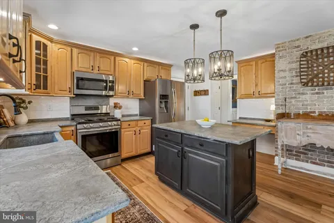 a kitchen with center island and stainless steel appliances