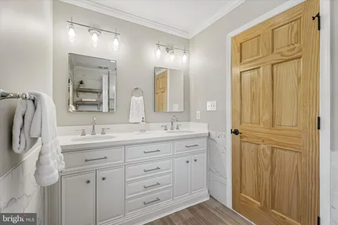 a bedroom with a bed chandelier and a window