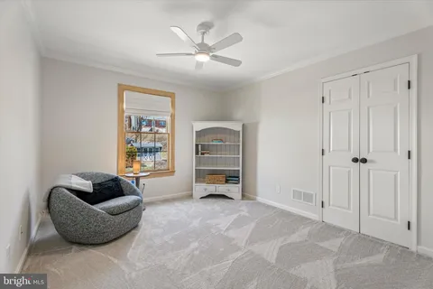 a bedroom with a white bed and a chandelier