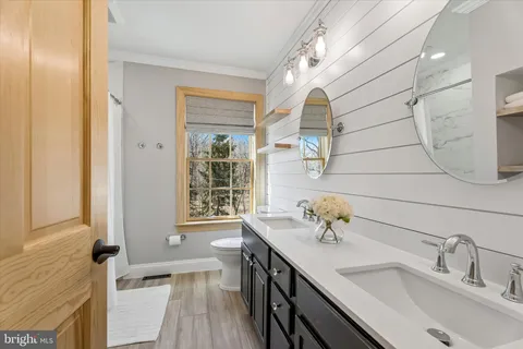 a view of a patio with couches table and chairs and potted plants