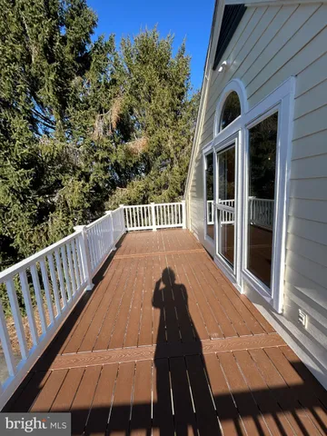a view of balcony with wooden floor and seating space