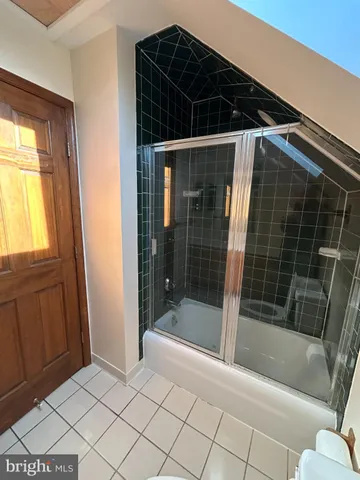 a bathroom with a shower and a bathtub