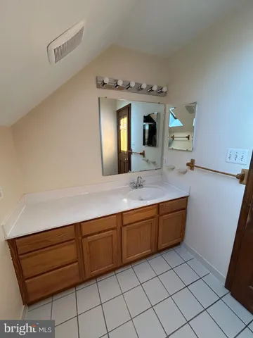 a spacious bathroom with a sink a mirror and a bathtub