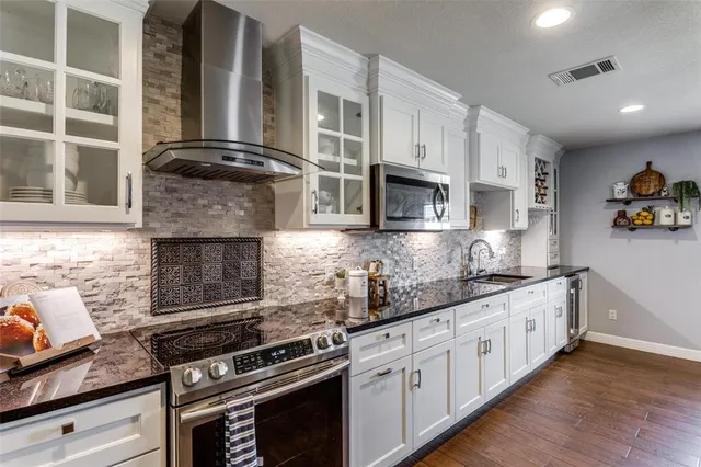 a kitchen with stainless steel appliances granite countertop a stove and a granite counter tops