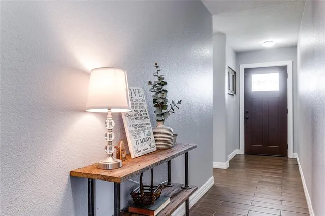 a view of a hallway to a house and wooden floor