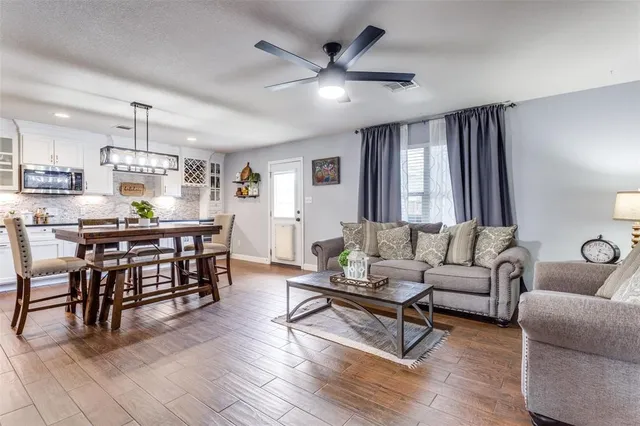 a living room with furniture and kitchen view