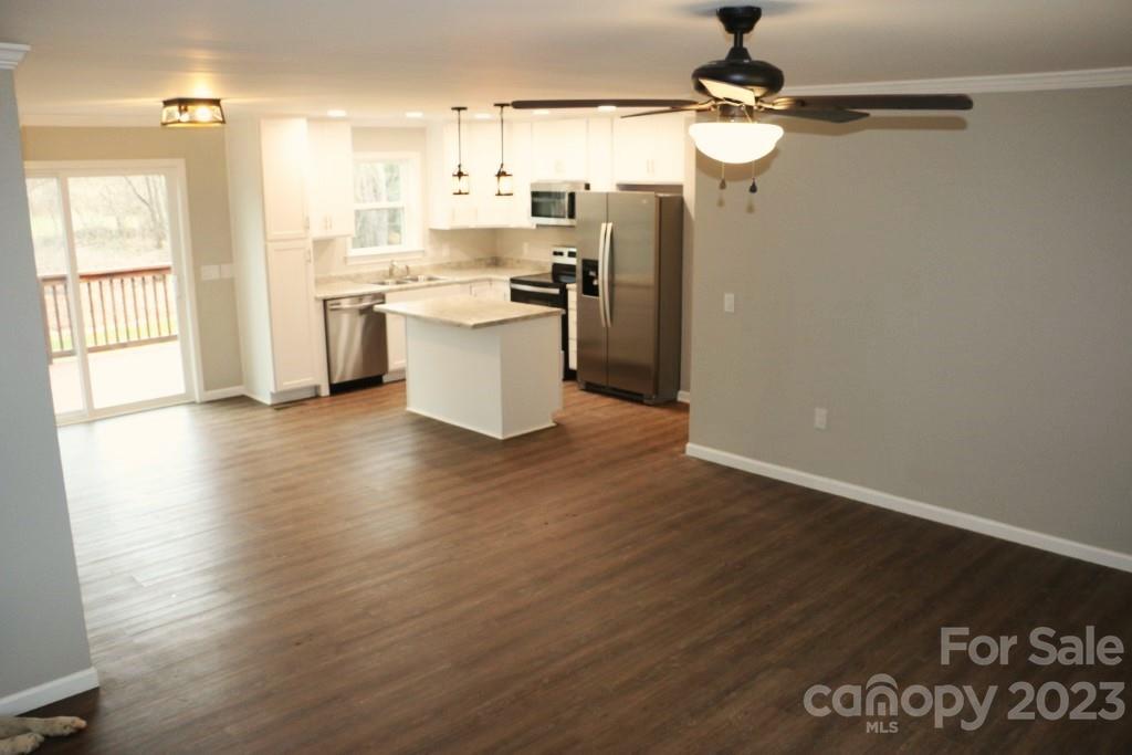 314 John Smith Road Rutherfordton, NC 28139 - Photo 11 of 25 a kitchen with stainless steel appliances granite countertop a refrigerator a sink dishwasher a stove and a dining table with wooden floor