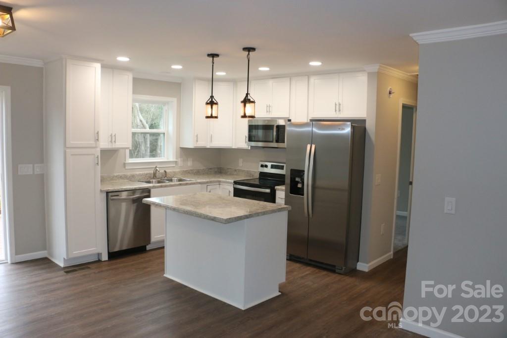 314 John Smith Road Rutherfordton, NC 28139 - Photo 12 of 25 a kitchen with stainless steel appliances granite countertop a refrigerator a sink a stove and white cabinets with wooden floor