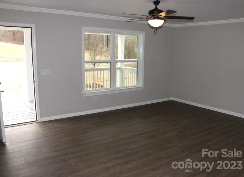 314 John Smith Road Rutherfordton, NC 28139 - Photo 10 of 25 an empty room with wooden floor fan and windows