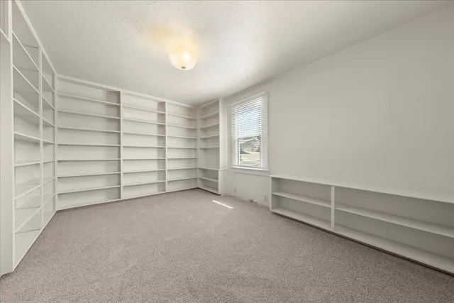 a view of an empty room with shelves