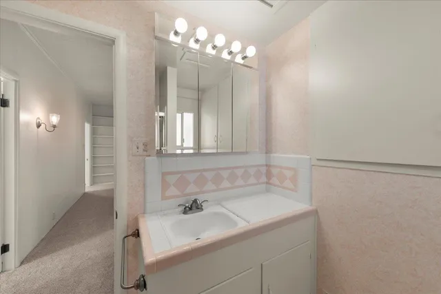 a bathroom with a sink and a mirror