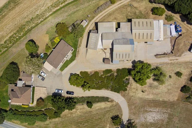 an aerial view of a house with a yard