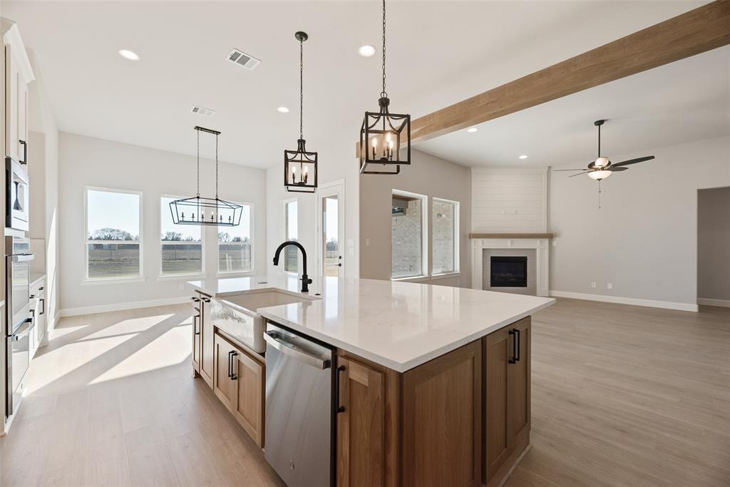 5251 Sunset Road Caddo Mills, TX 75135 - Photo 11 of 32 a very nice looking kitchen with a wooden floor and a chandelier