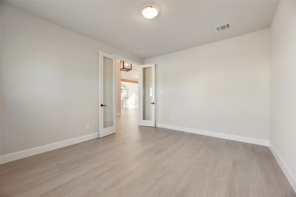5251 Sunset Road Caddo Mills, TX 75135 - Photo 12 of 32 an empty room with wooden floor and windows
